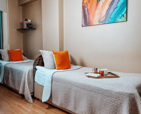 Nuvola Kız Öğrenci Yurdu 4 Kişilik Oda Nuvola Kız Öğrenci Yurdu 4 Kişilik odalarında, 4 adet yatak bulunuyor. Bu görselde kadraja yatakların 2 tanesi girmiş. Yataklar bej örtülerle kapatılmış iki adet yastık yatağın üzerinde.